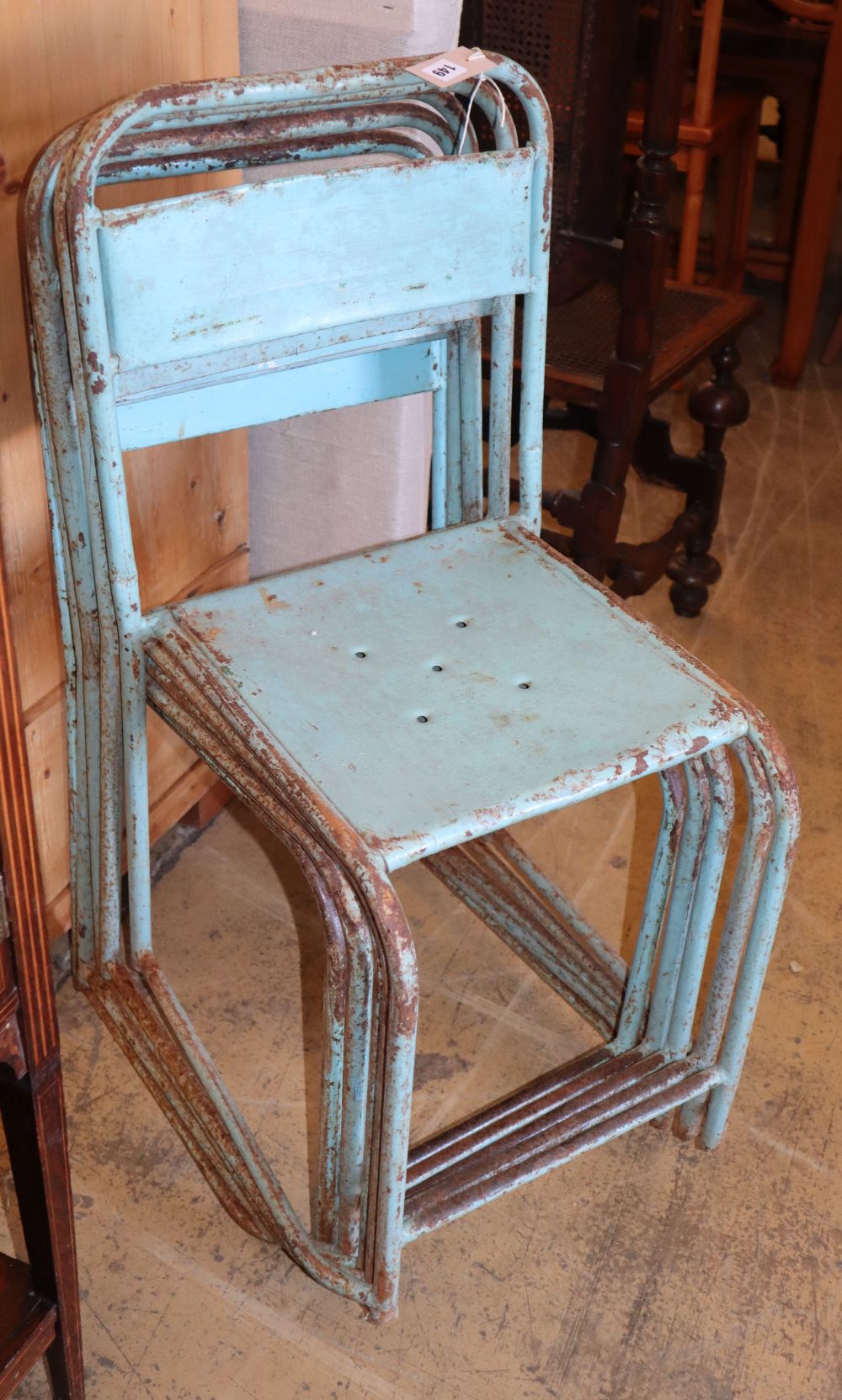 A set of five vintage painted metal stacking chairs
